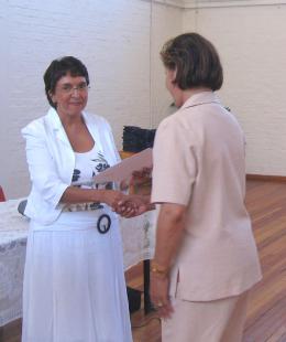 Berenice Daniels (Chief Education Specialist) presents a certificate to a teacher-mediator